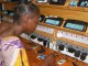 A villager in Garoua-Boulai, Cameroon charges phones at a solar power station