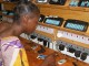 A villager in Garoua-Boulai, Cameroon charges phones at a solar power station
