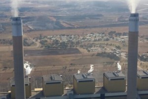 Smoking stacks of an Eskom power station. In the background is a human settlement, in close proximity to the power station and its air pollution. Photo: Melissa Fourie/CER